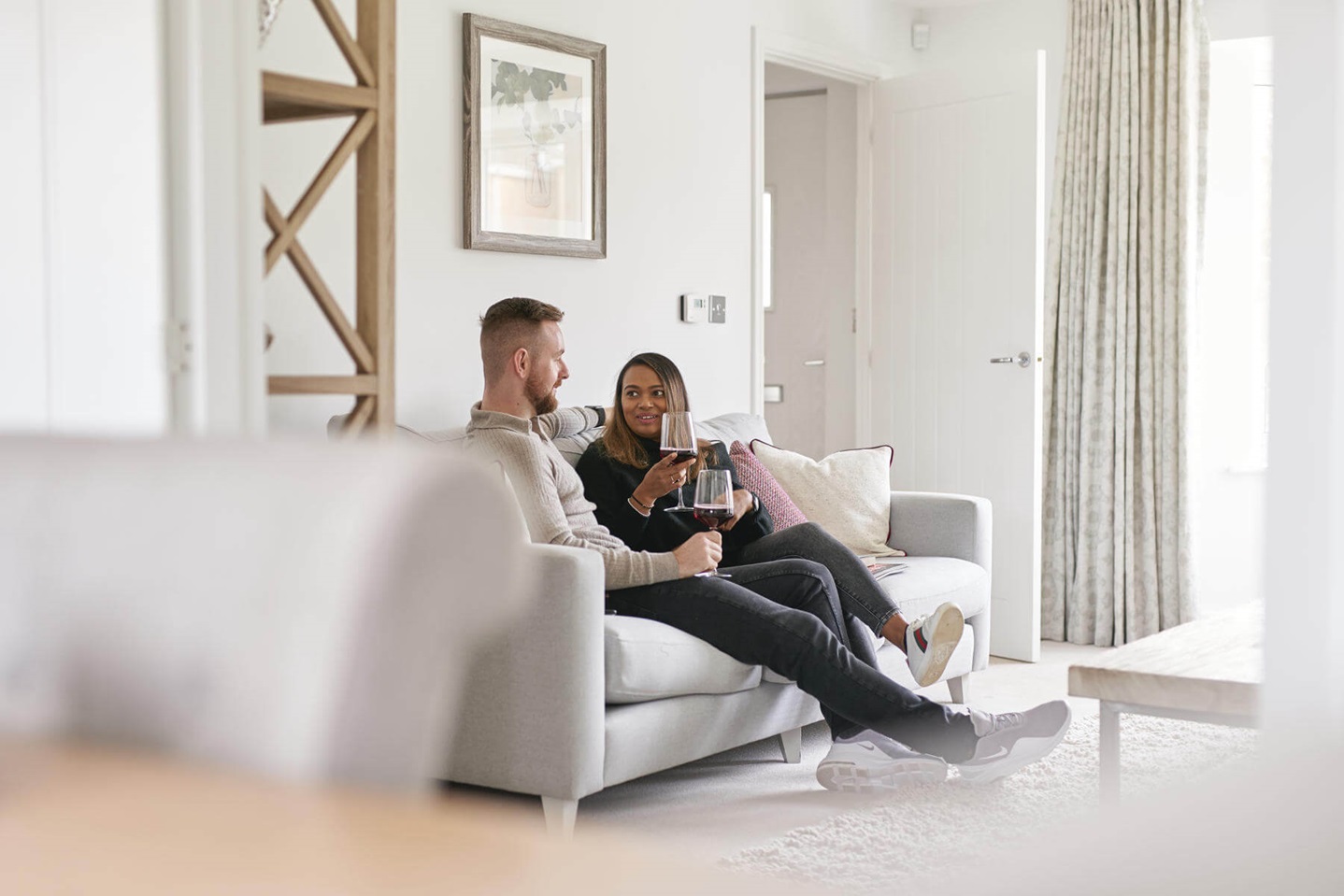A couple in their Taylor Wimpey living room