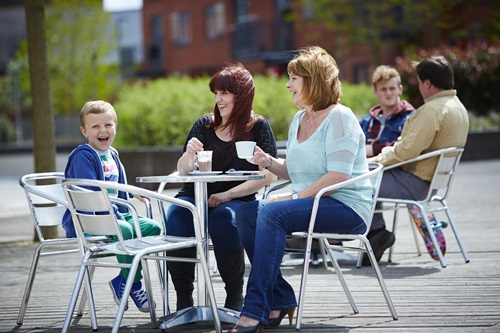 Family drinking coffee at local cafe